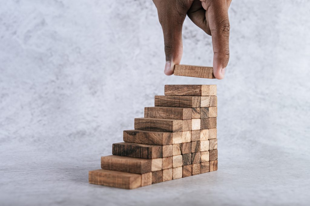 Stacking wooden blocks is at risk in creating business growth id